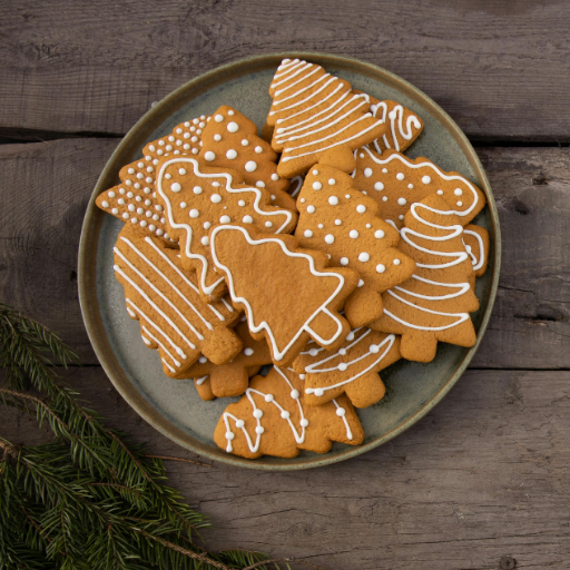 A tray of soft, buttery Christmas cookies decorated with icing and sprinkles for the holiday season.