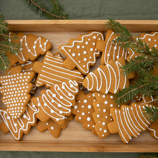 Freshly baked Christmas cookies cooling on a wire rack before decorating.