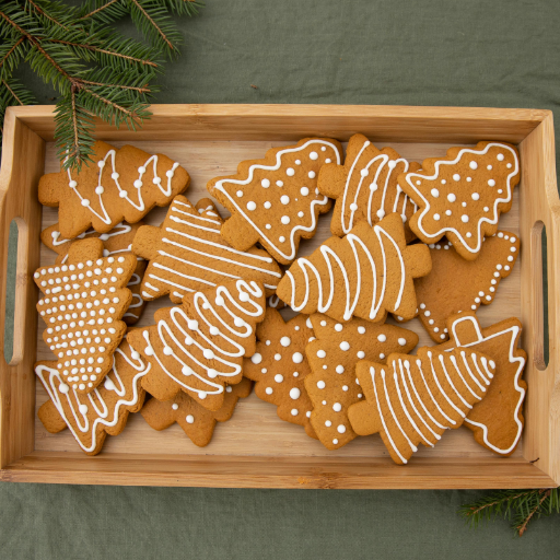 Baking ingredients for Christmas cookies including butter, sugar, flour, eggs, and holiday spices.