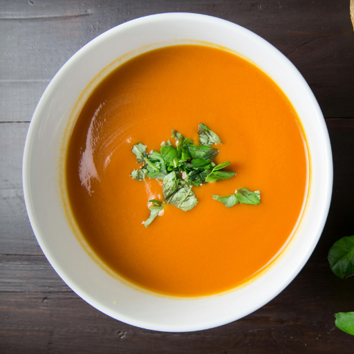 Warm bowl of homemade soup with vegetables and herbs